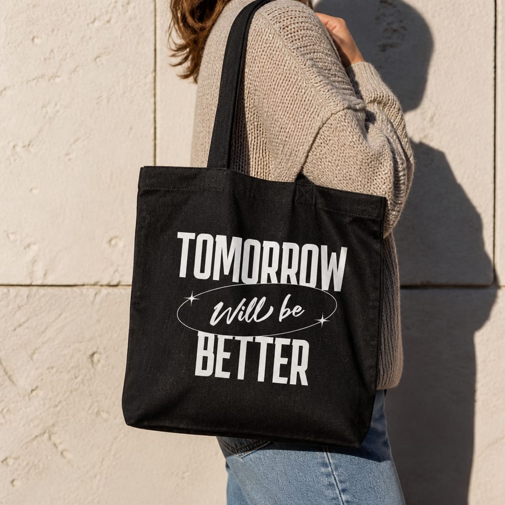 Black tote bag mockup carried in the sun